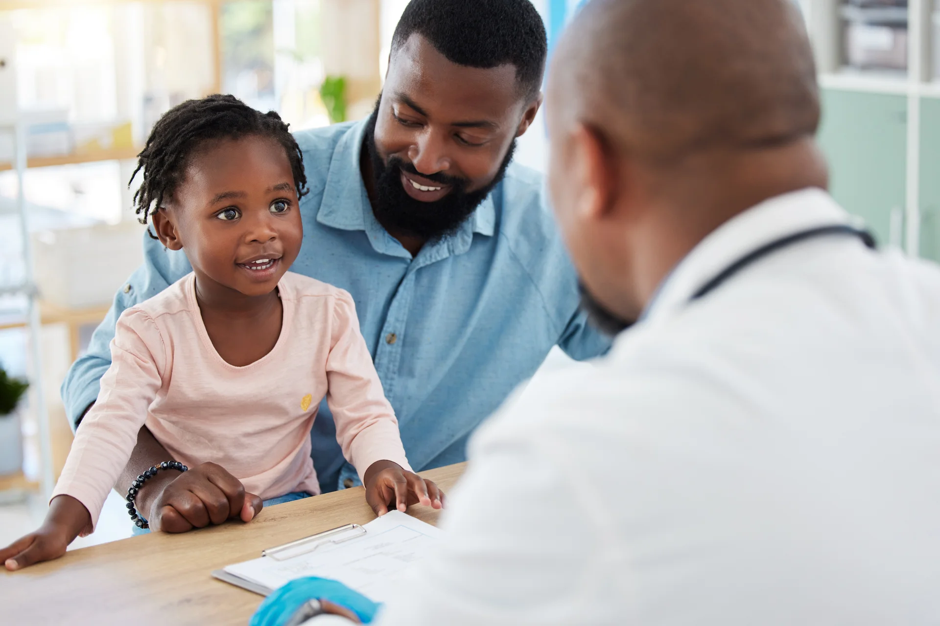 Father and child with healthcare professional